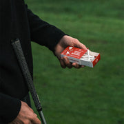 Box of Red Golf Tees from Three Putt Round featuring multiple tees arranged inside a match box style container.